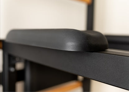 The 733B — pull-up bar, dip station, and bench on one wall.